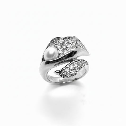 Sculptural sterling silver white rhodium plated wrap ring with pavé cubic zirconia and a single freshwater pearl.